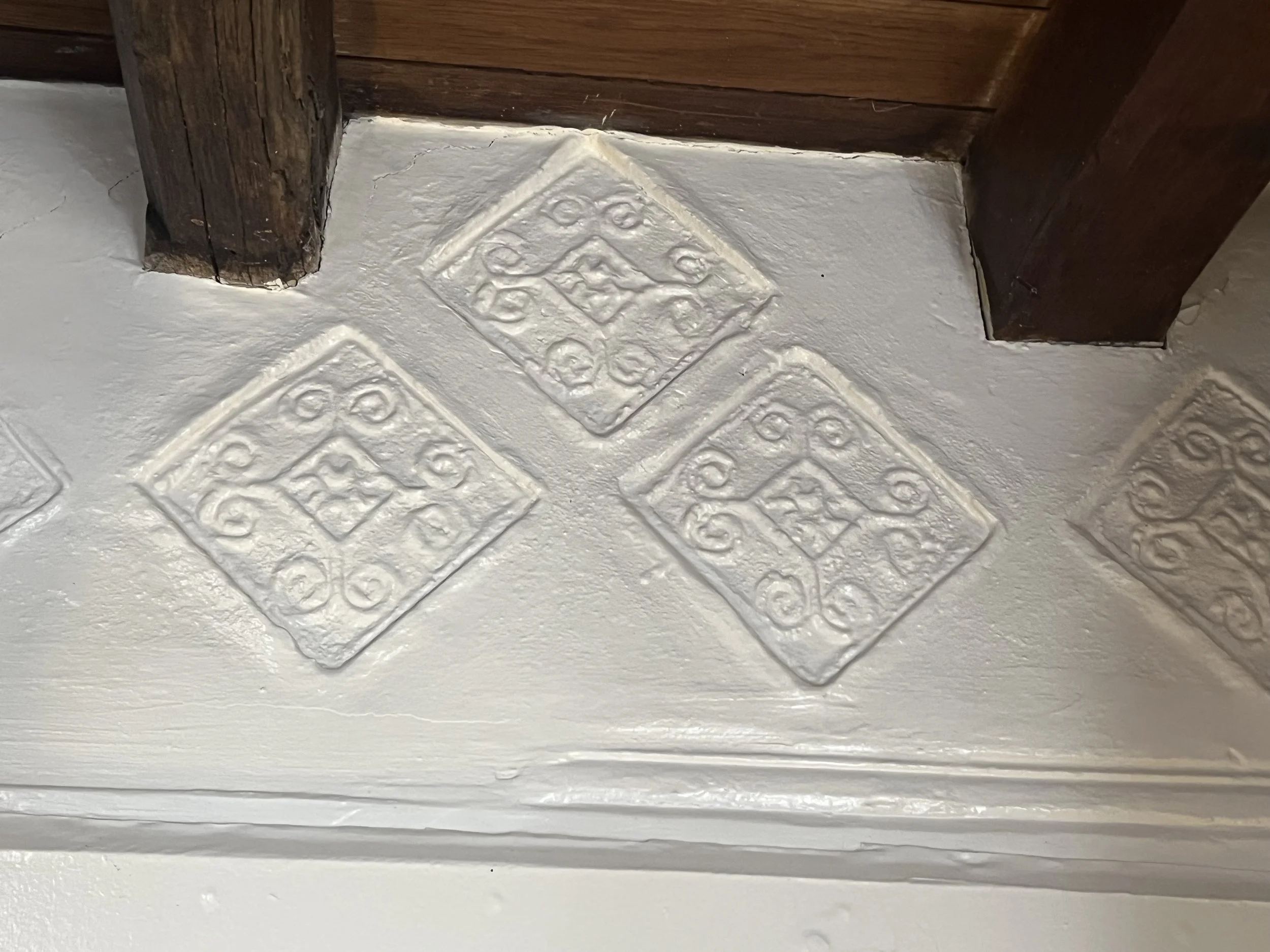 Sixteenth cetury plasterwork depicting diamonds with scrolls within