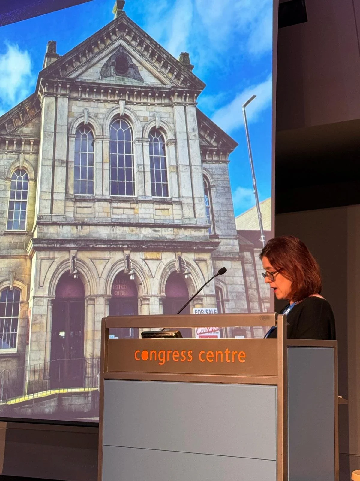 Stefanie speaking at a podium