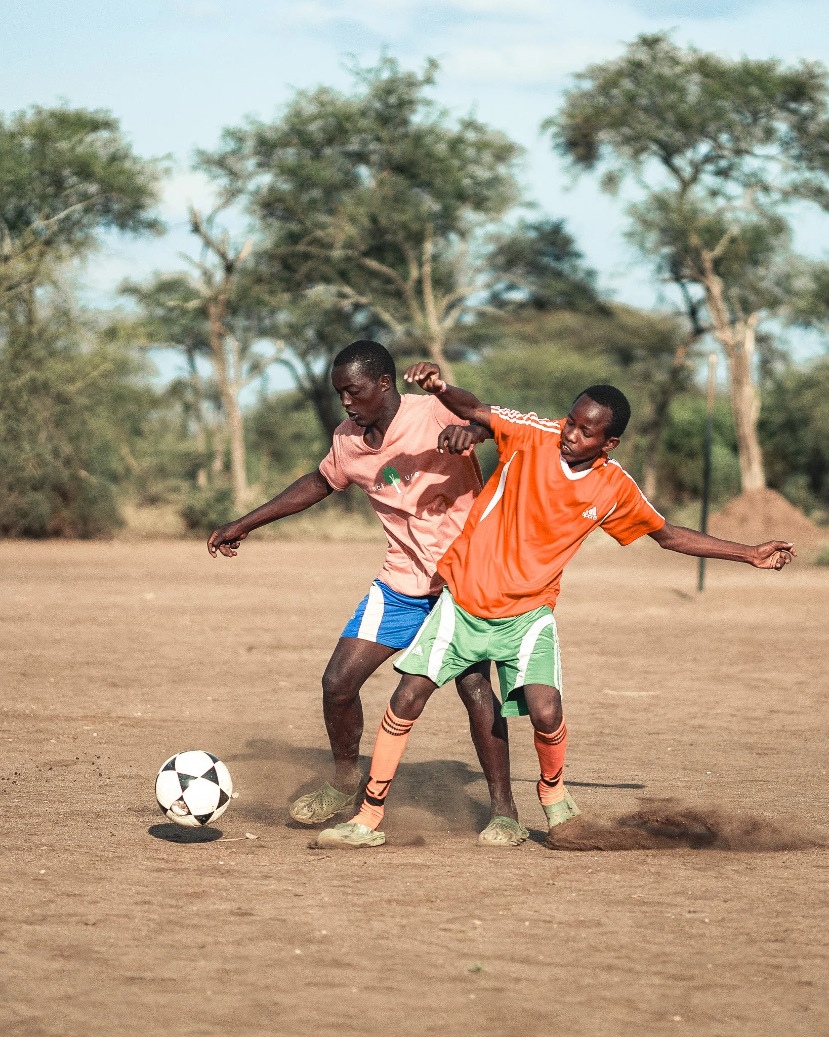 Two young men playing soccer