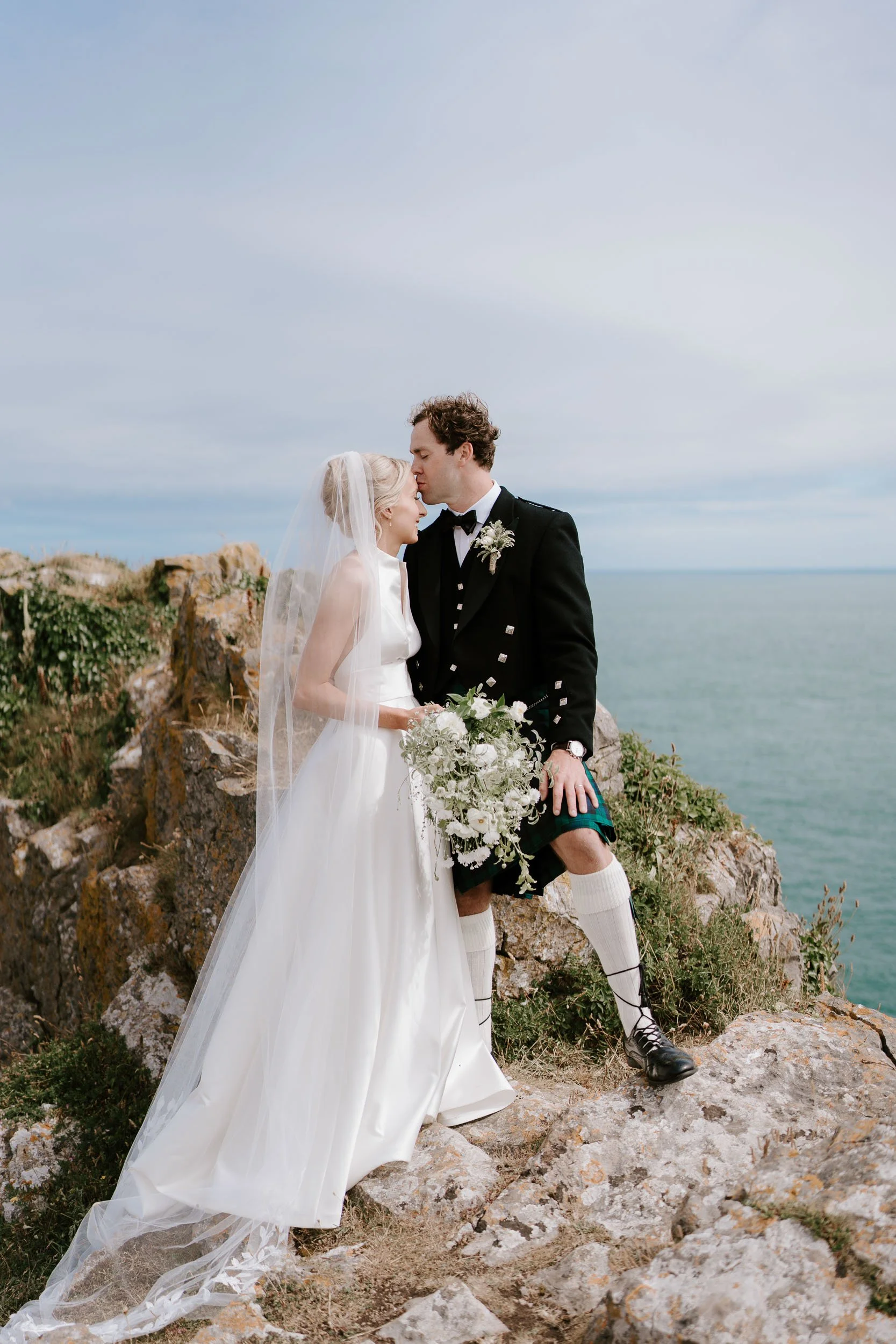 Bride and groom coastal cliff wedding portrait seaside UK