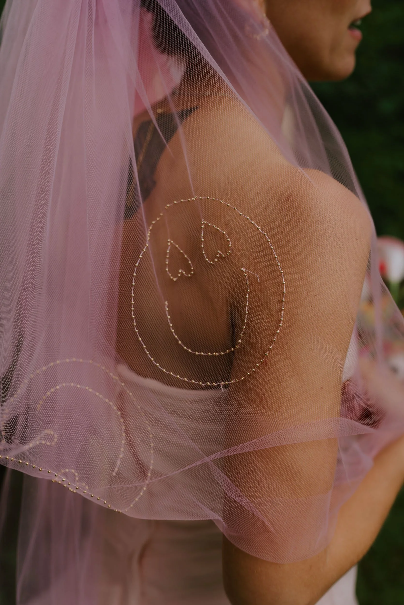 Wedding detail shot of bridal veil with embroidered initials captured naturally