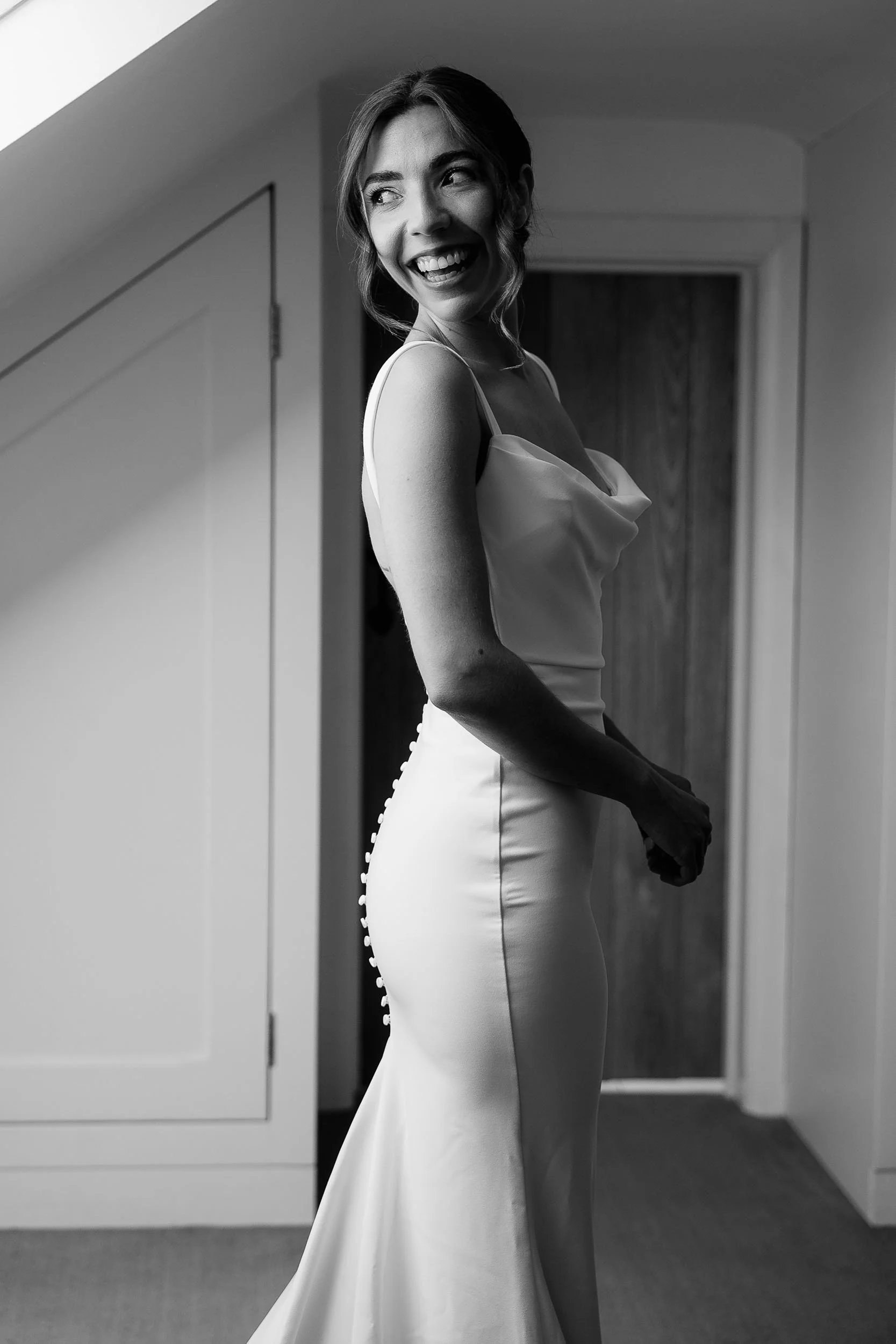 Bride getting ready dress moment natural window light candid