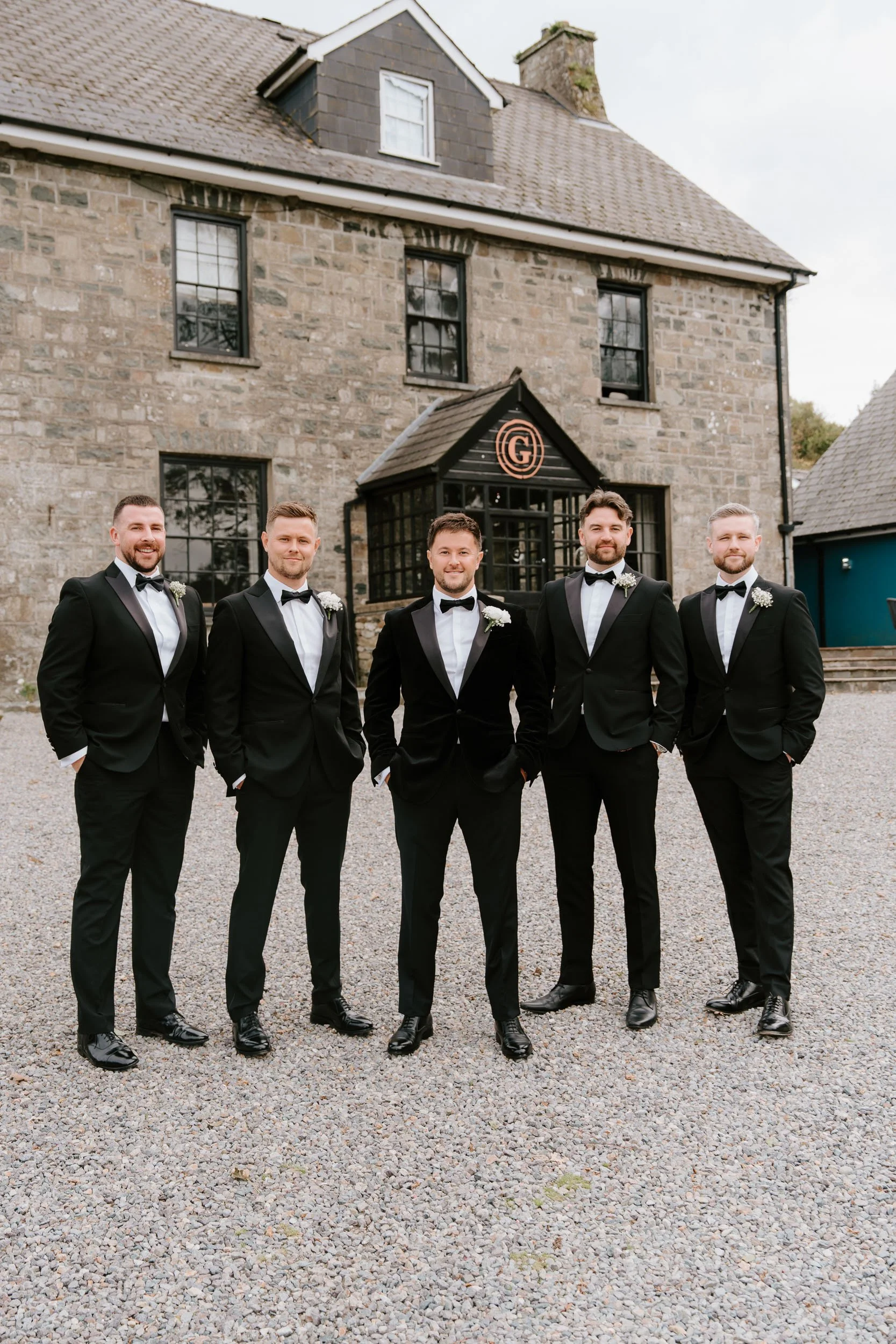 Groom and groomsmen outside Gellifawr woodland retreat
