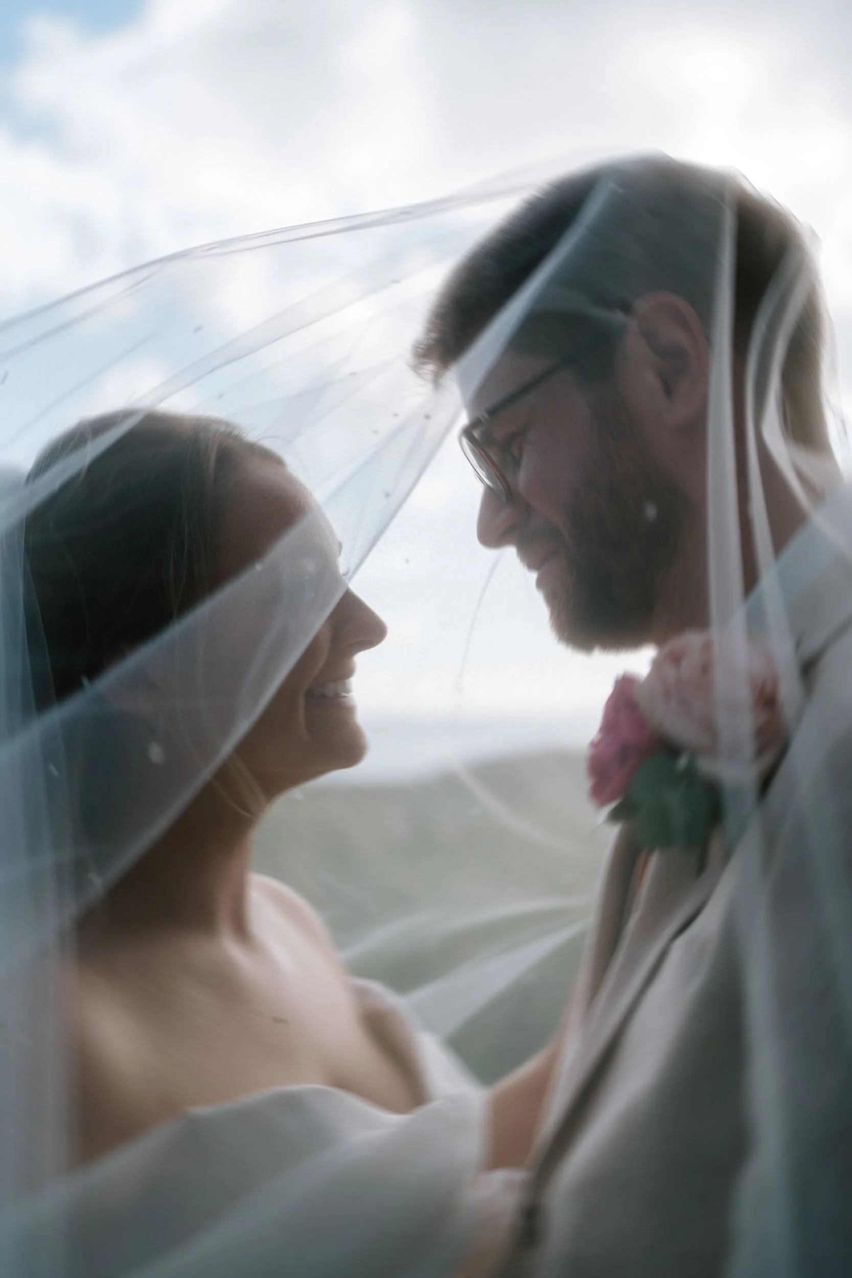 Bride and groom veil portrait soft natural light romantic moment