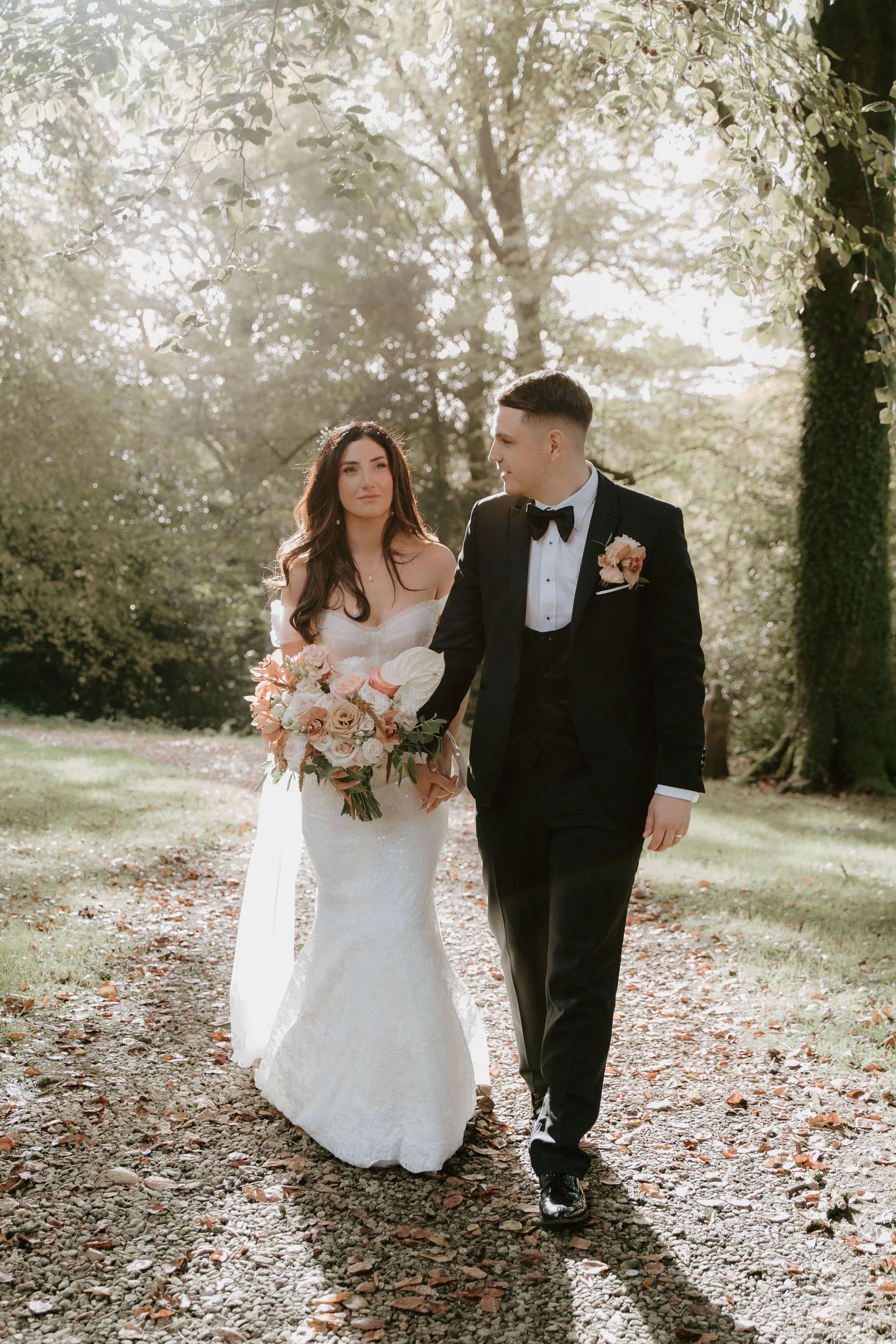 Bride and groom walking together natural wedding portrait outdoors