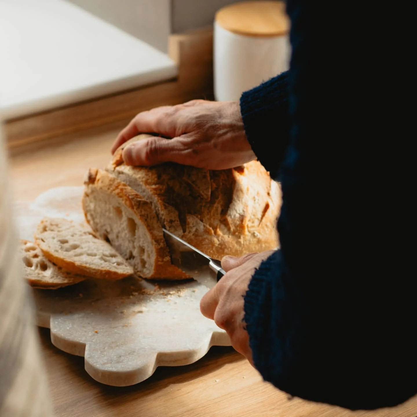 The Sunday Slow No. 10 🤎📷
&ldquo;Before the bread cooled&rdquo;

The loaf had only just been brought to the board, still carrying the warmth of the morning with it.

There was a quietness in the kitchen, the kind that seems to settle around small f