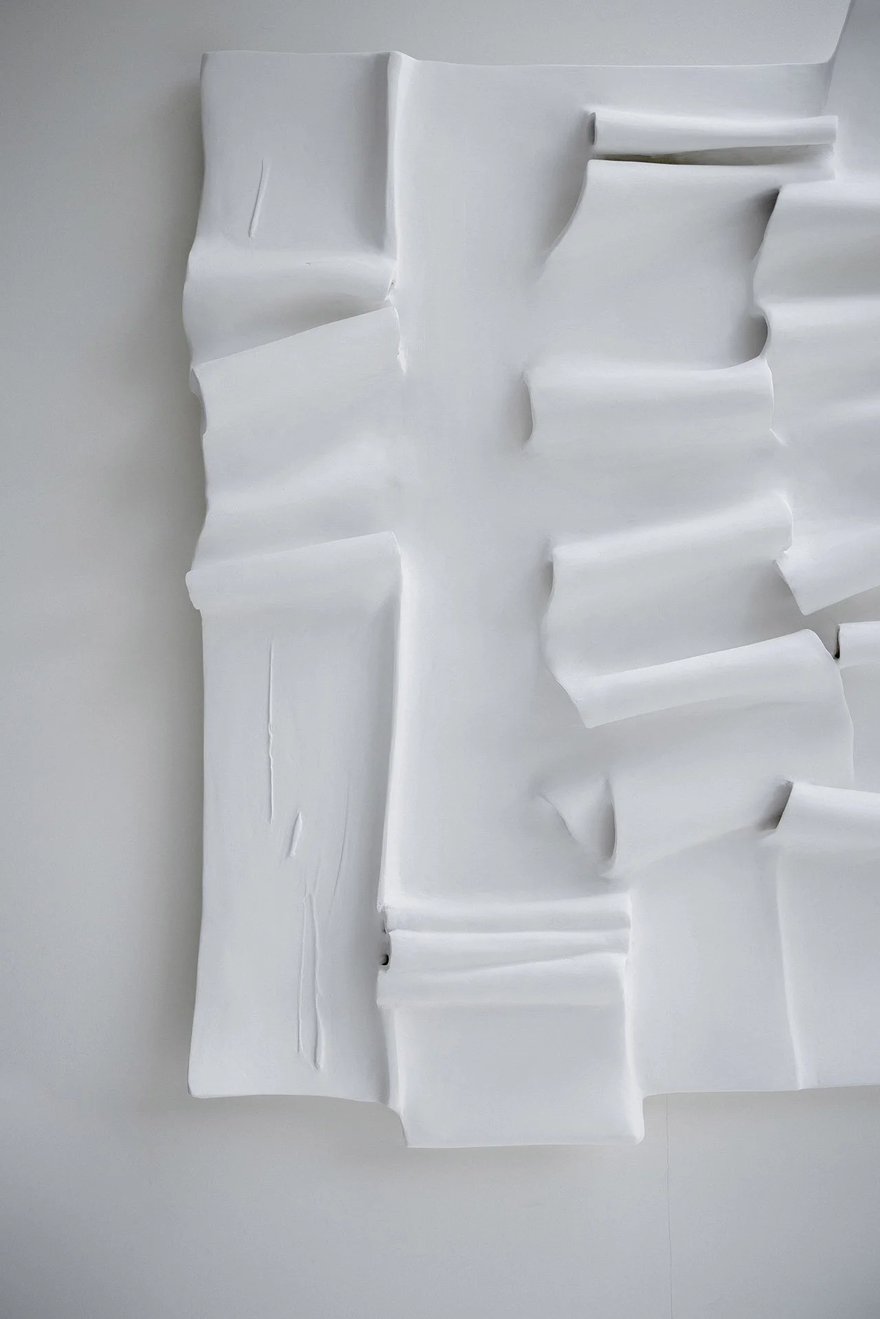 Fabric-and-plaster technique detail - sculptural wall art folds and low-relief texture
