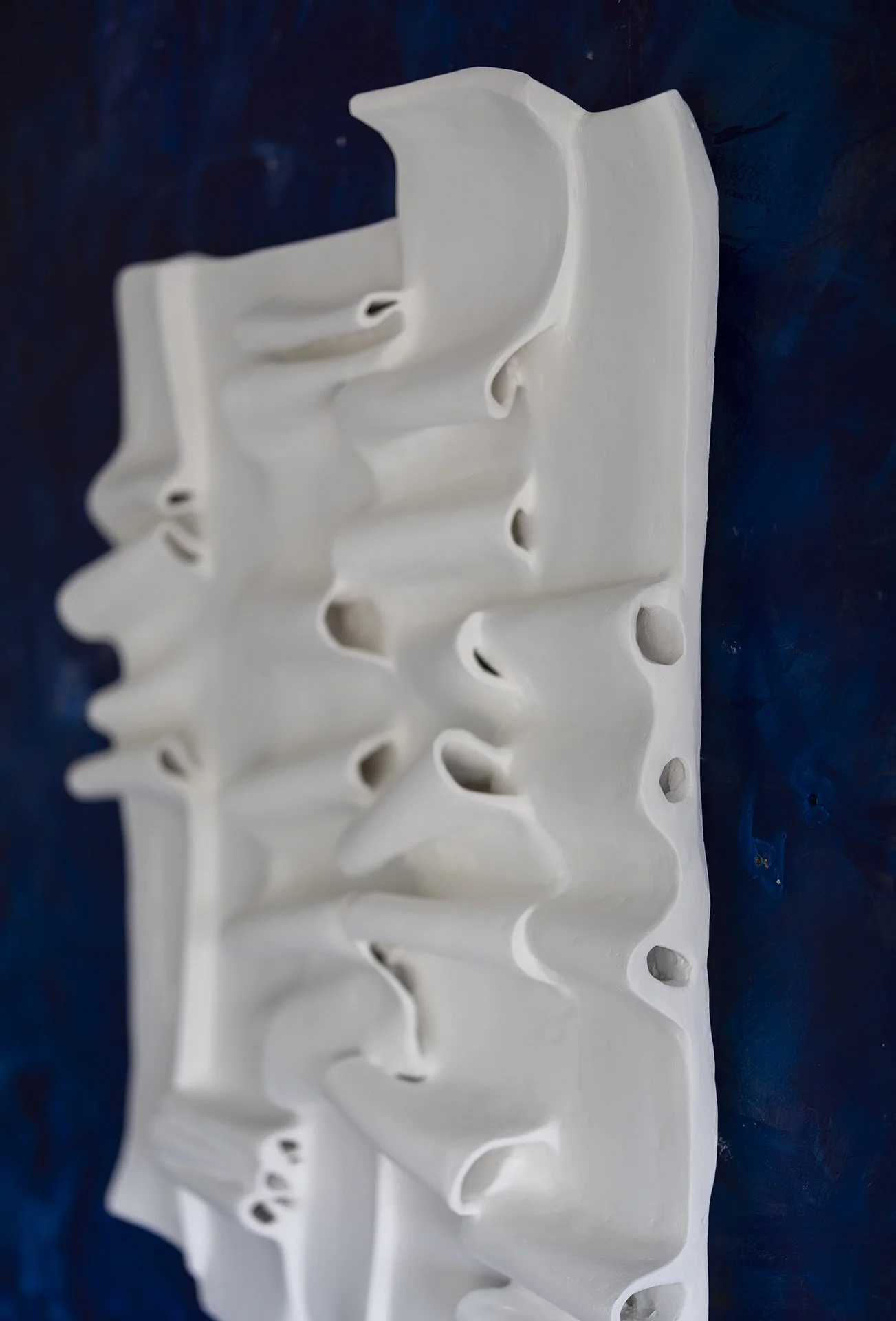 Close-up detail - white textured wall art in fabric and plaster for luxury interiors