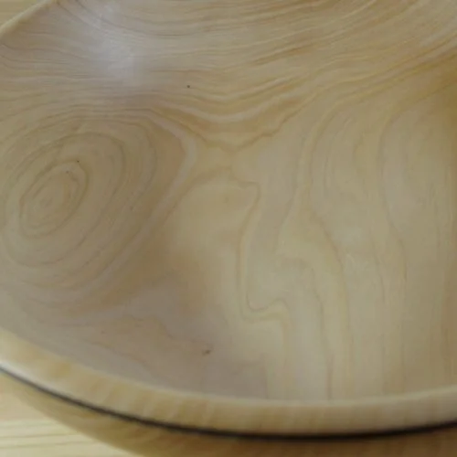 Close-up of a wooden bowl showing wood grain patterns.