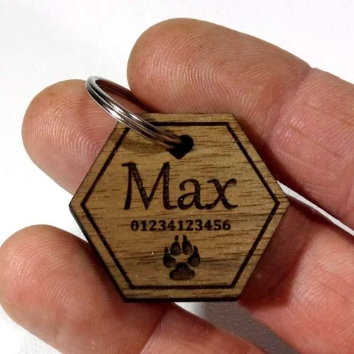 Wooden pet tag with the name 'Max', a phone number, and a paw print, attached to a metal key ring.