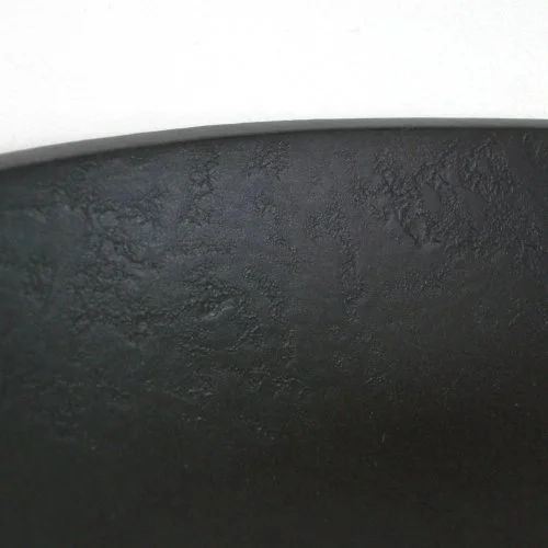 Close-up of textured black bowl interior.