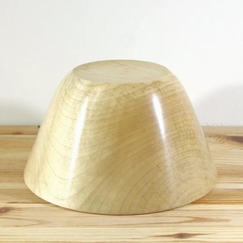 Wooden upside-down bowl or cap on a wooden surface