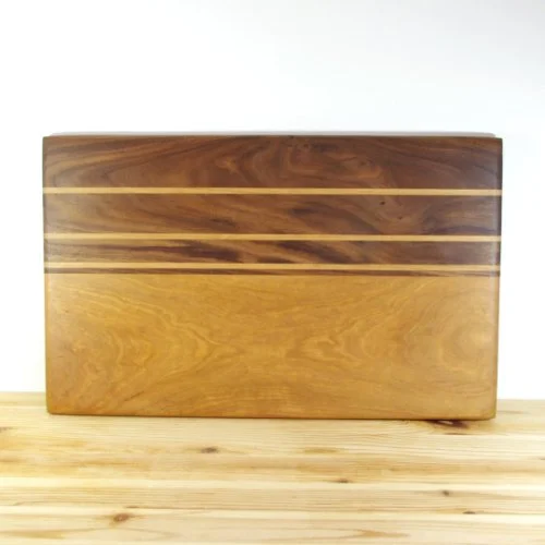 Maple and Walnut chopping board with horizontal decorative strips, placed on a wooden surface.