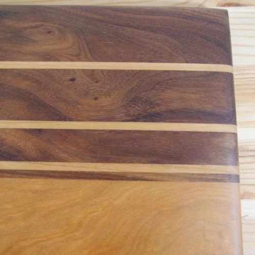 Maple and Walnut chopping board with alternating dark and light wood strips.