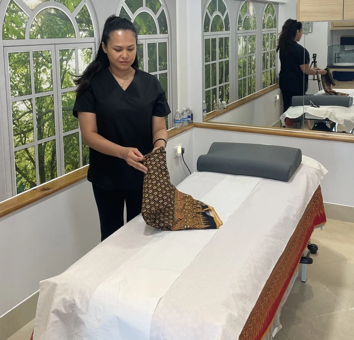 massage therapist preparing clinic massage room
