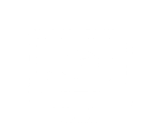 A blank, white rectangular sign or board with a small logo or symbol in the bottom left corner.
