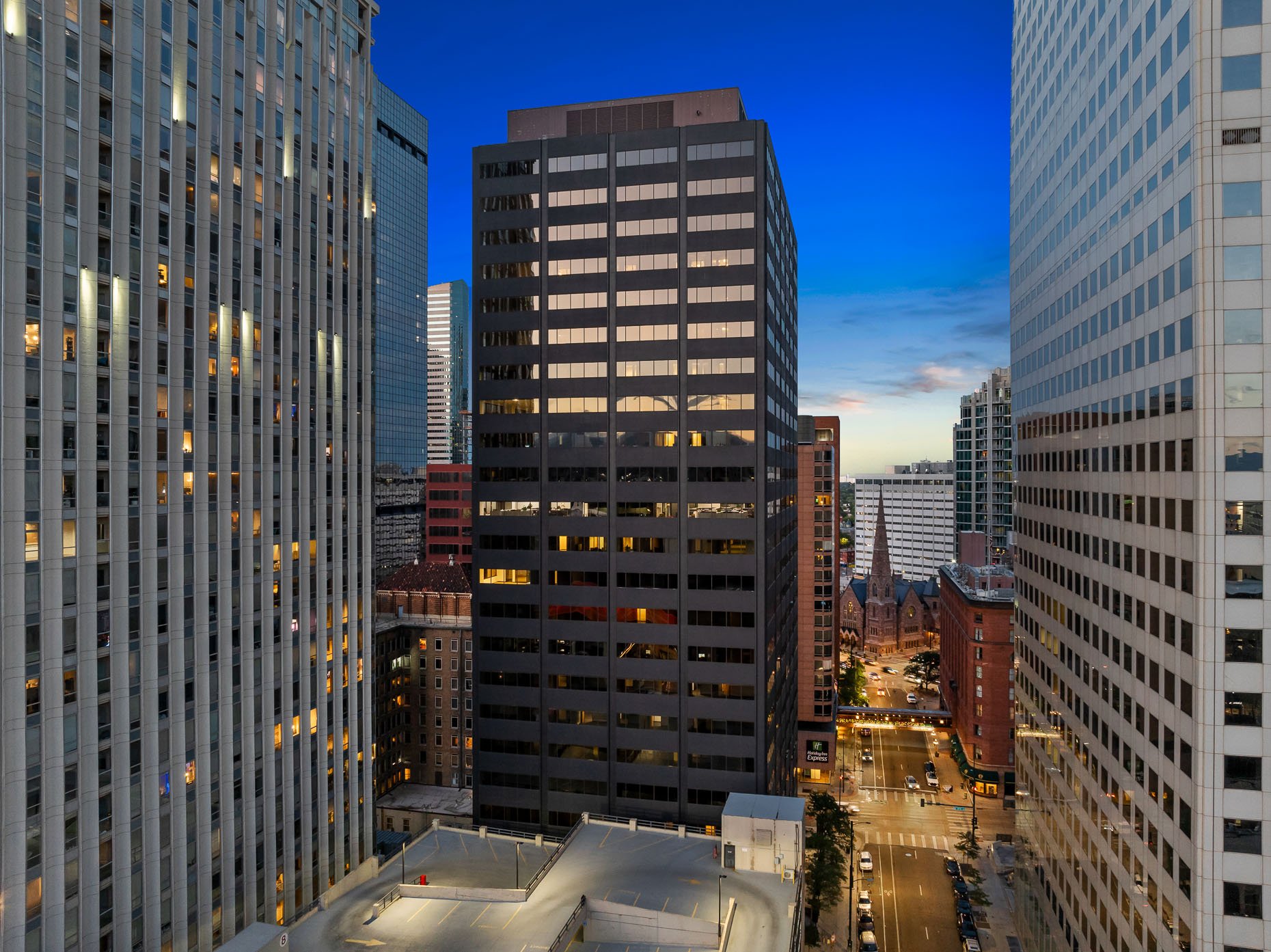 Dusk photo of exterior of building in downtown Denver