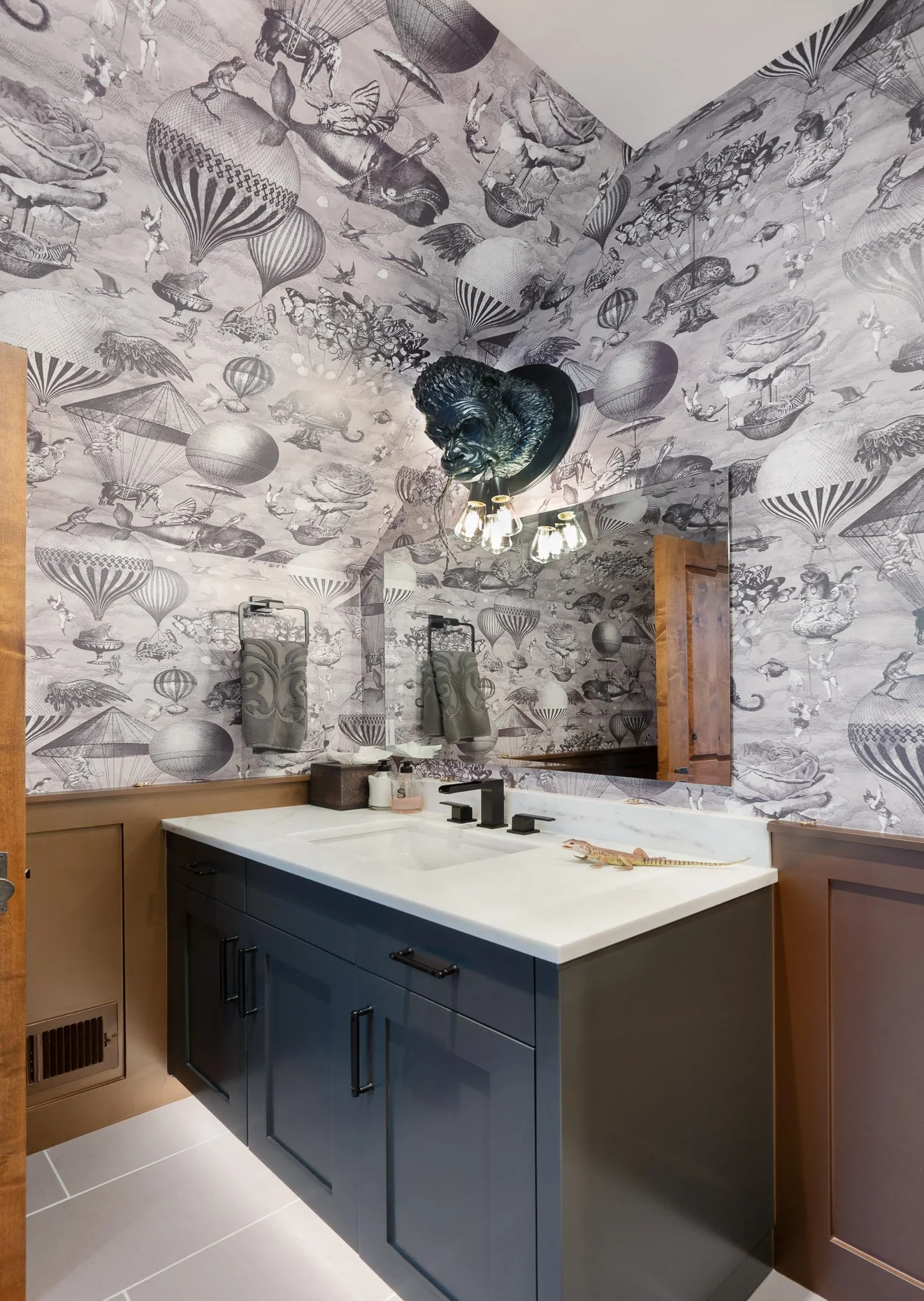 Monster bathroom with balloon wallpaper and dark vanity