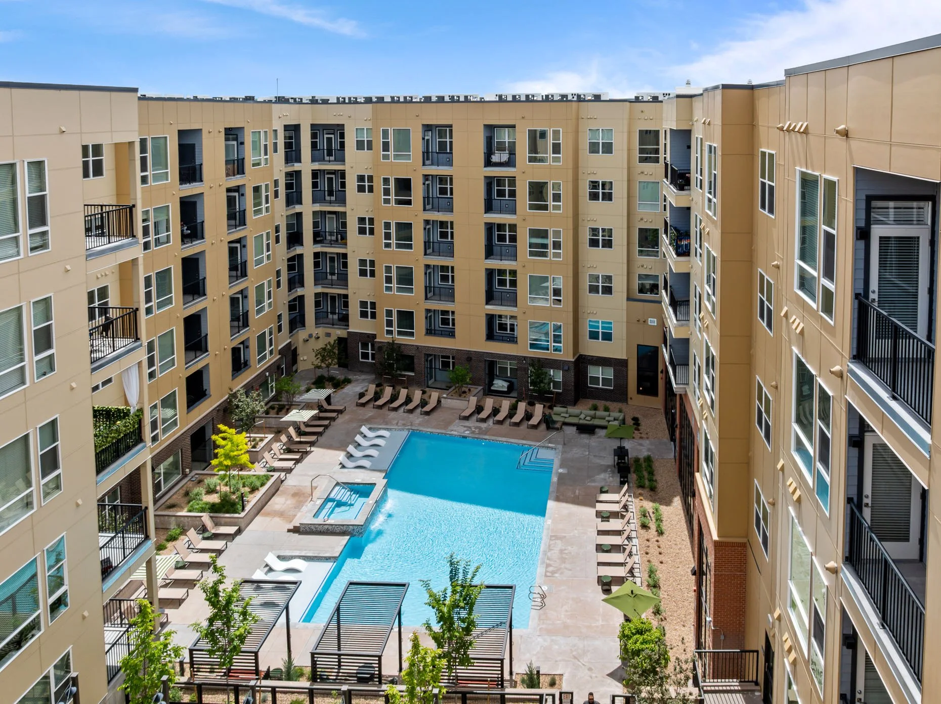 Drone view of daytime pool area in apartment complex