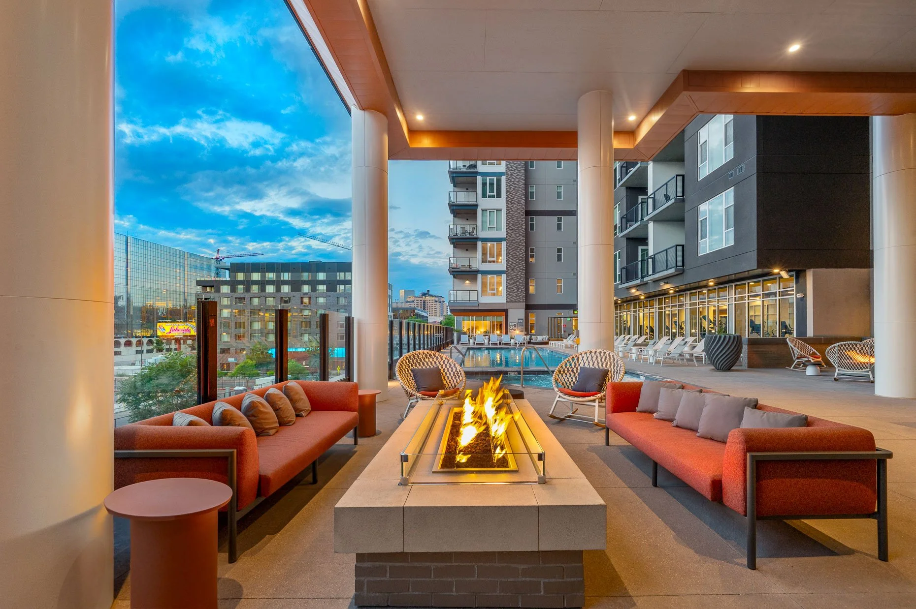 Multi-family fire pit area at dusk next to outdoor pool