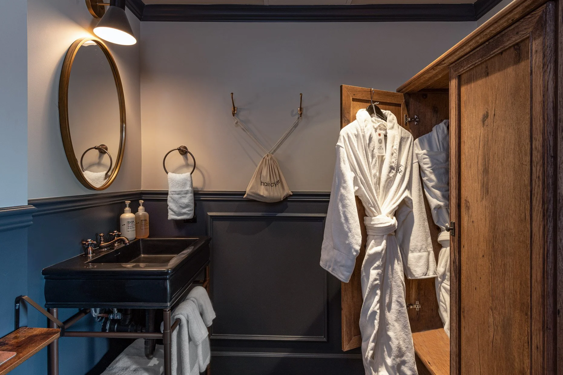 Hotel bathroom with wardrobe and robe