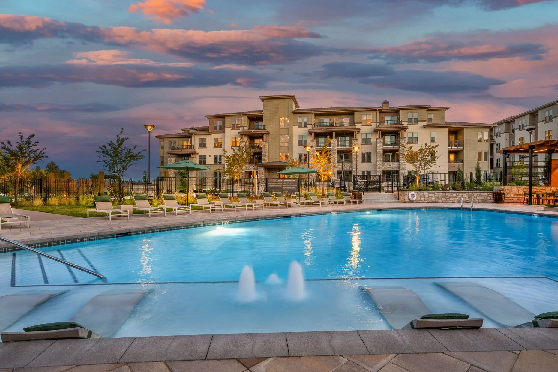 Pool area at dusk in apartment complex