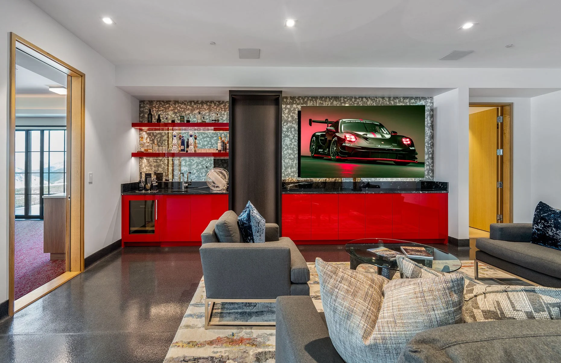 Fire engine red indoor heated garage area with seating and spaces for 6 cars