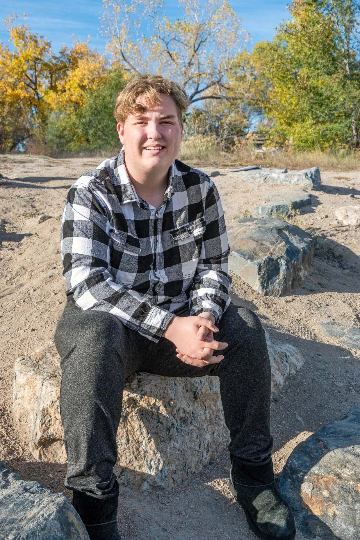 Senior boy sitting on rocks