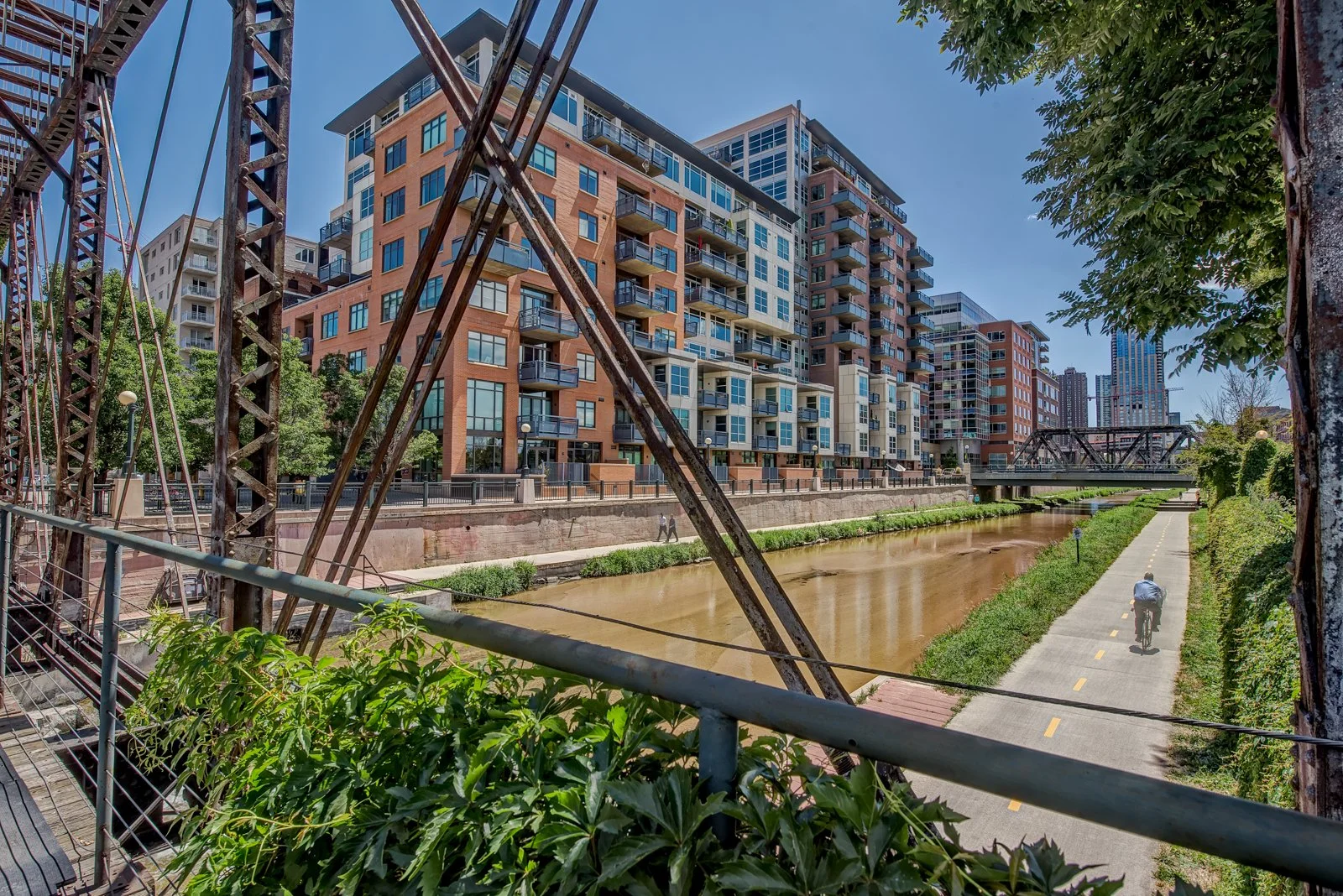 Exterior of apartment complex from bridge with bike trail