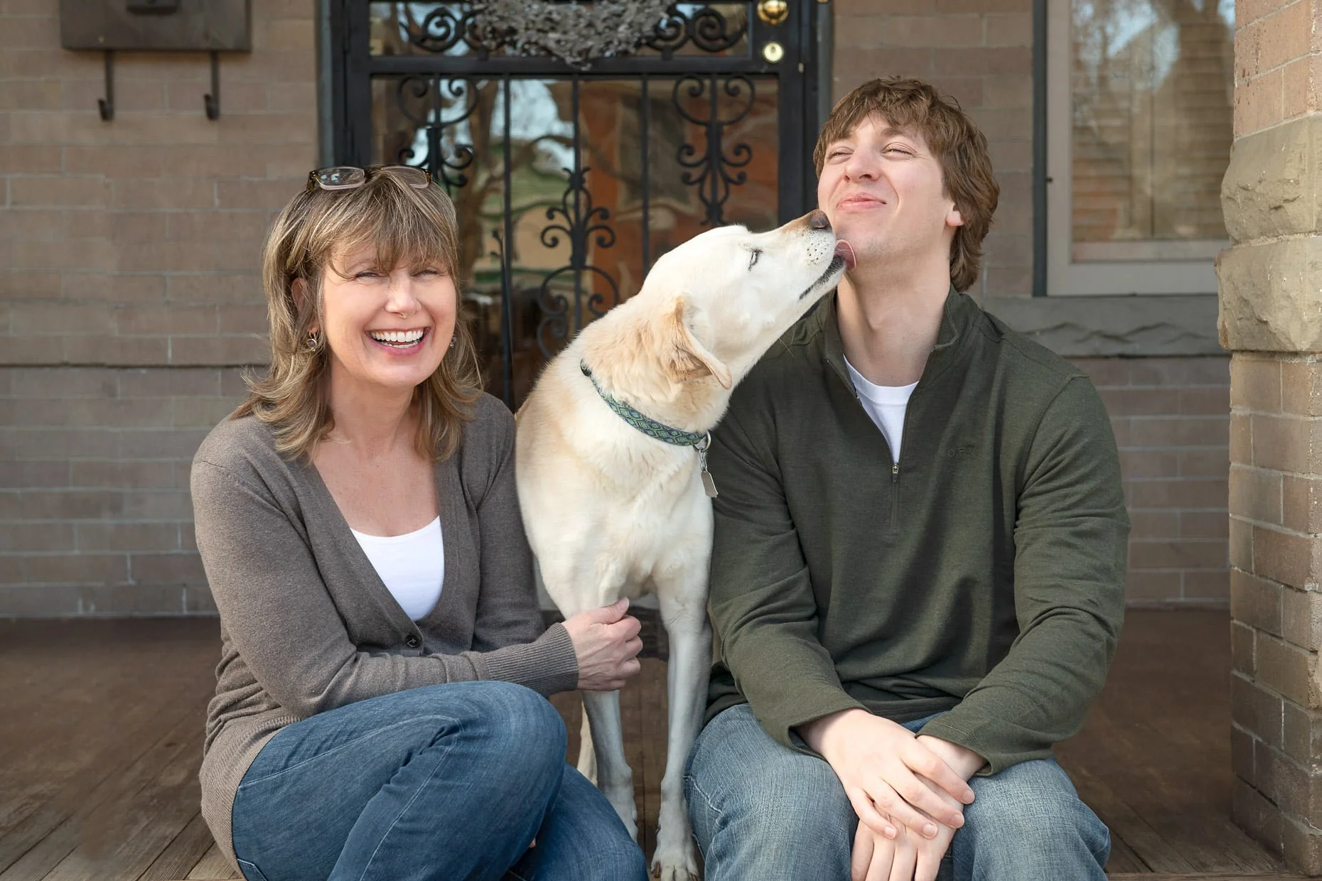 Woman with dog and man on front porch