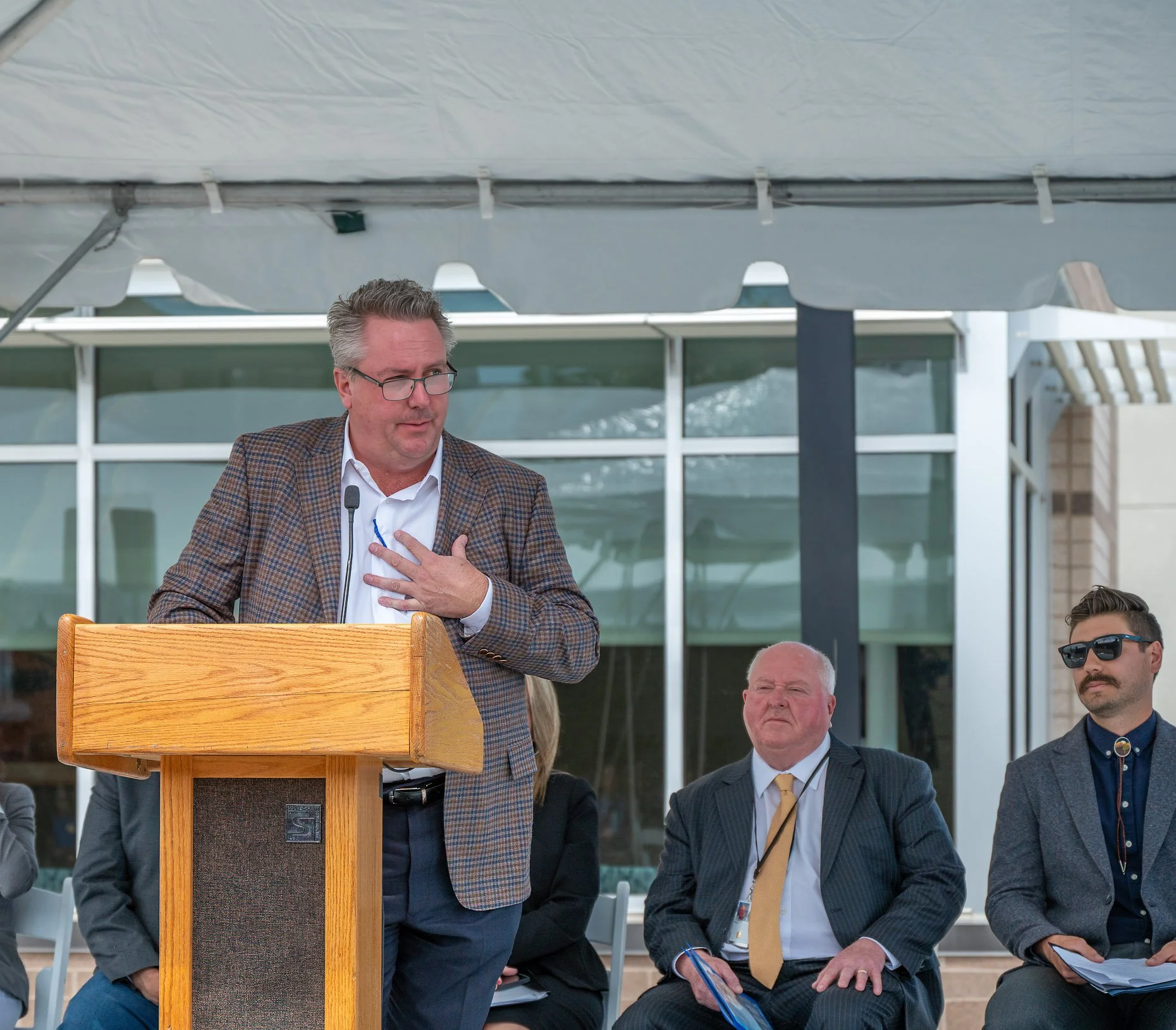 Speaker behind podium at ribbon cutting event