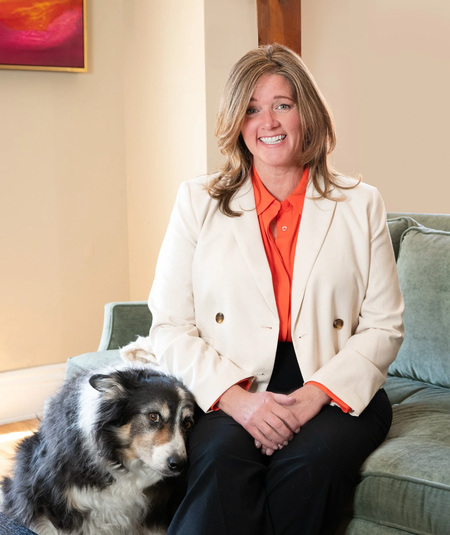 Woman sitting on couch with dog