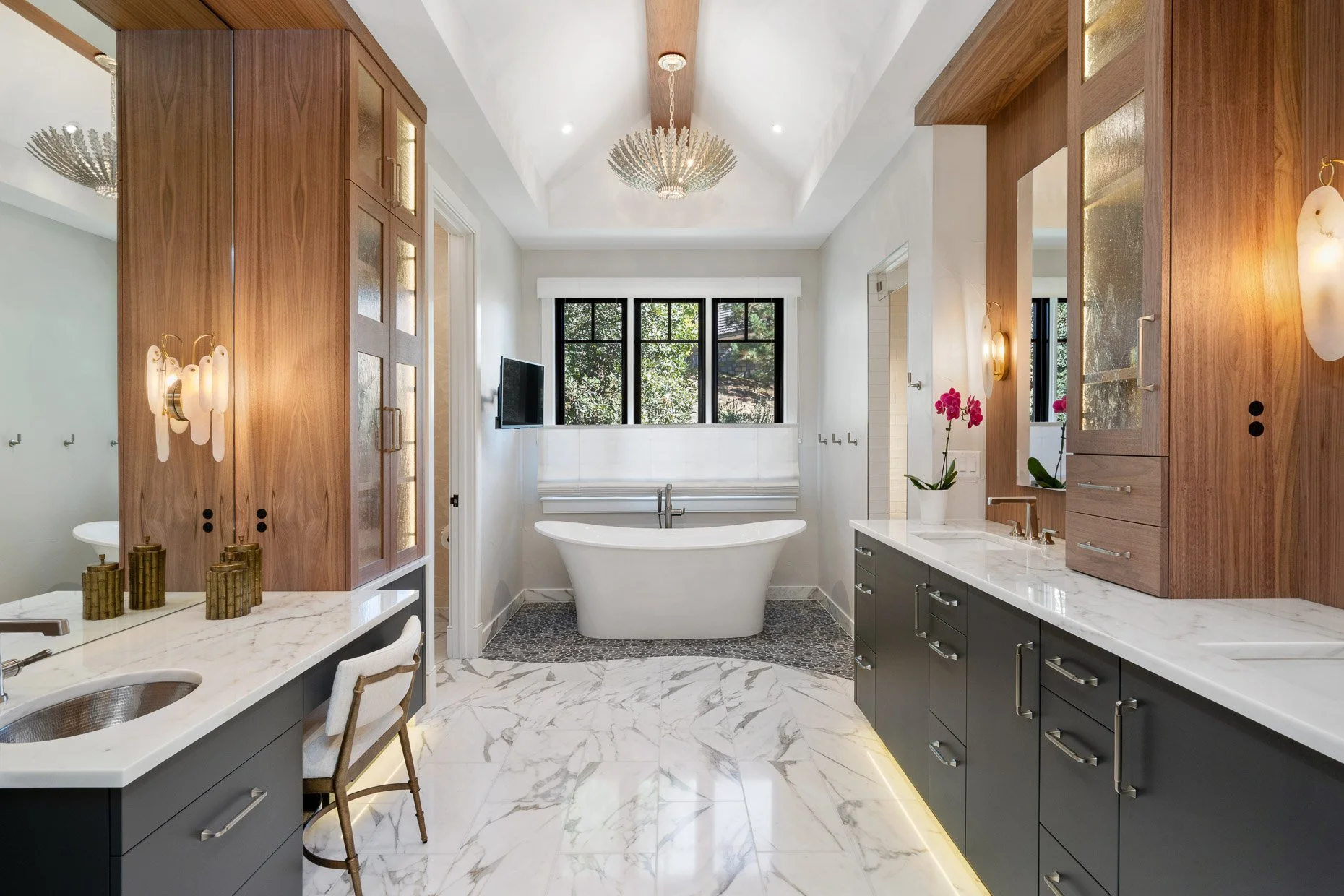 Award winning primary bath with stand alone tub, marble floors, chandeliers and gorgeous cabinetry