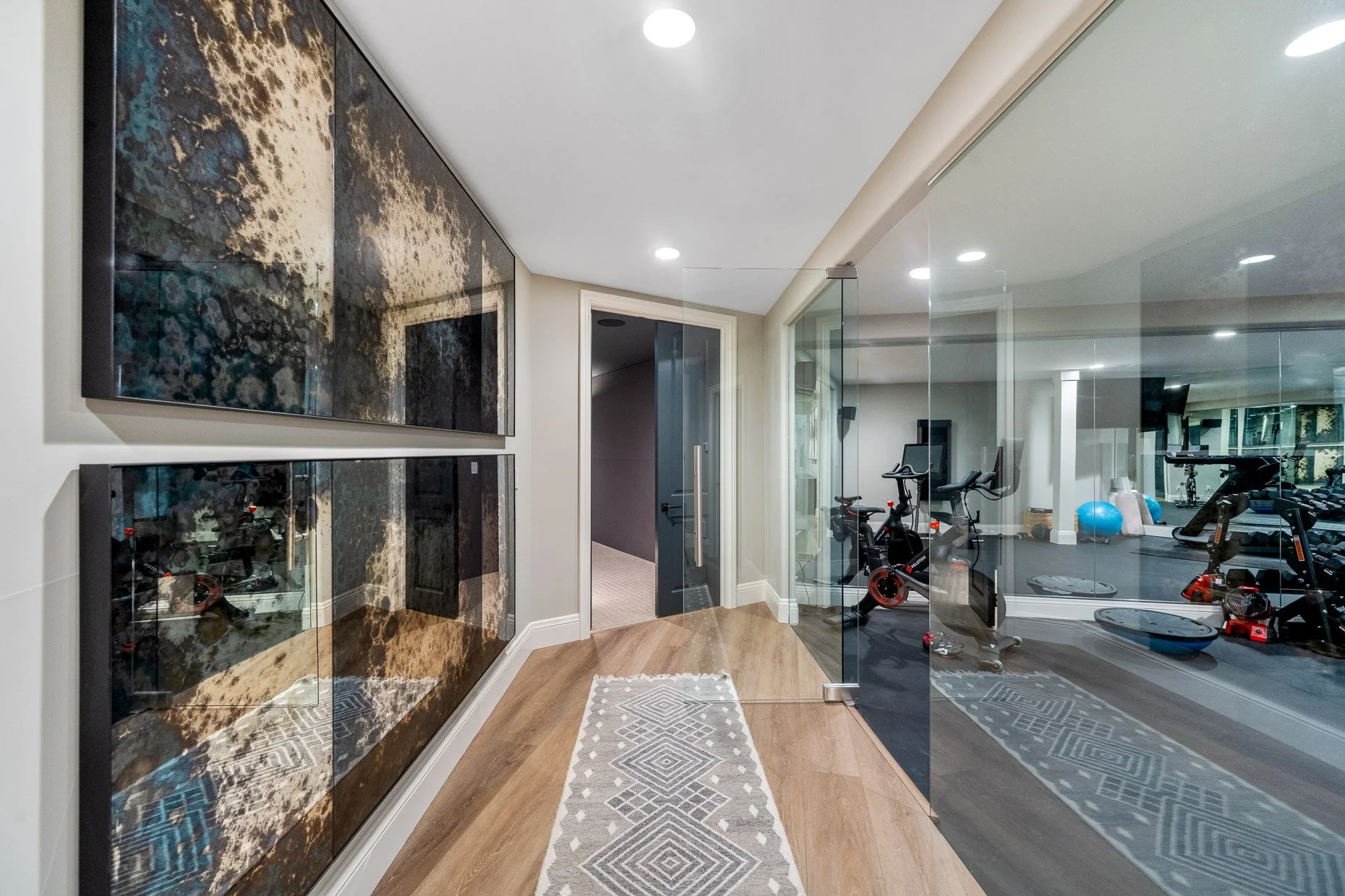 Hallway in elegant home with incredible wall design and home fitness room