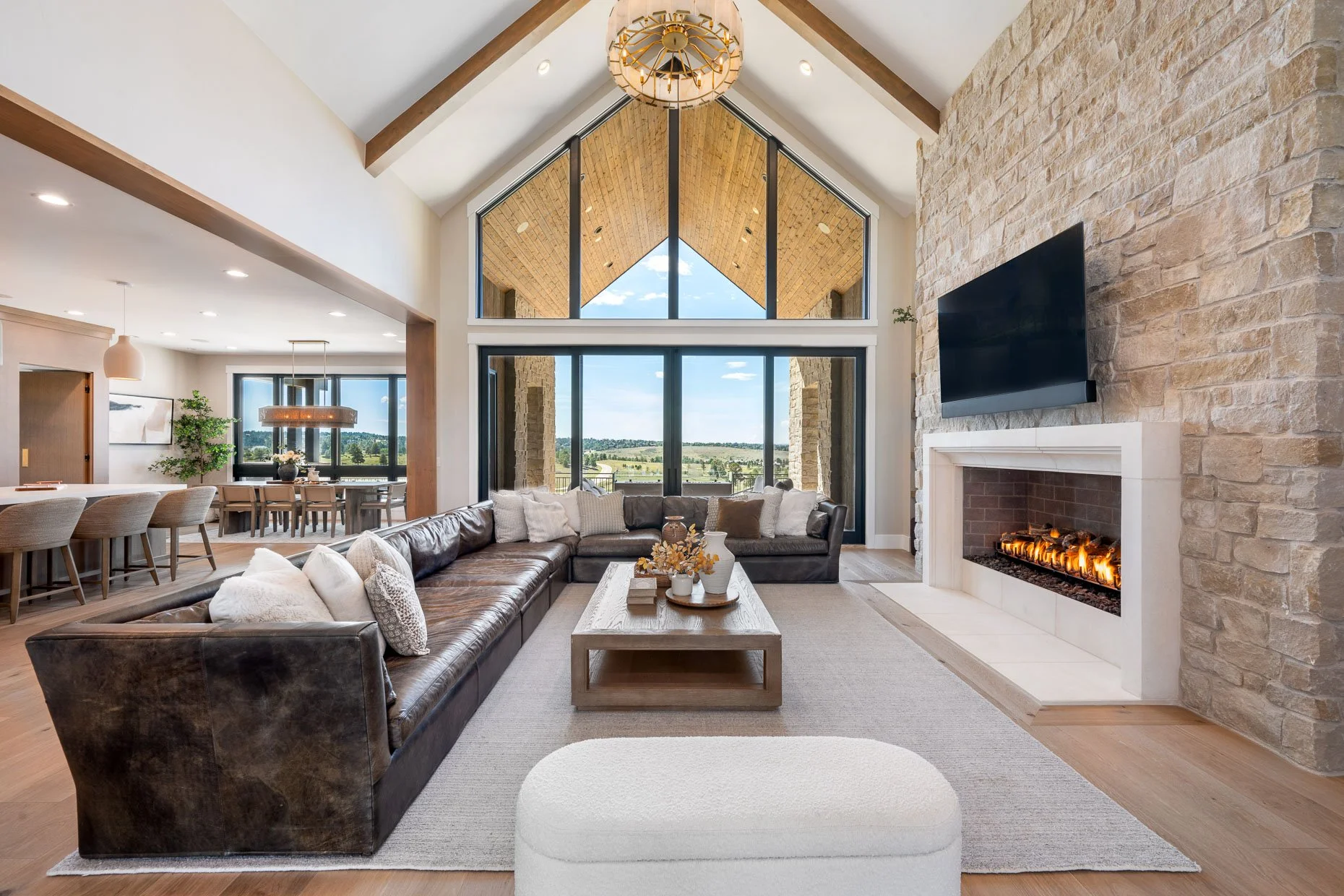 Family room with vaulted ceiling, large gas fireplace and rock wall