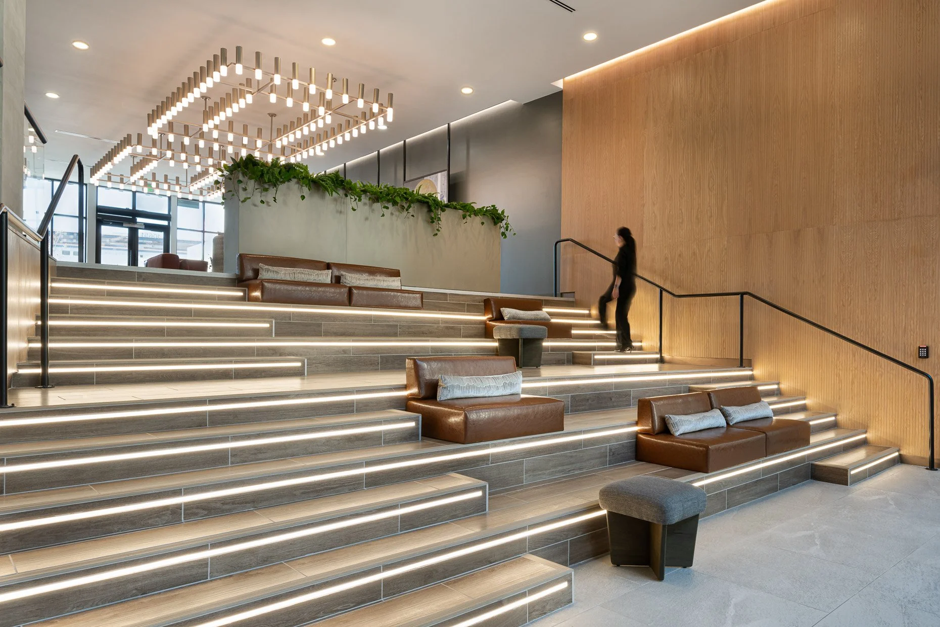 Person walking up lite staircase stadium seating