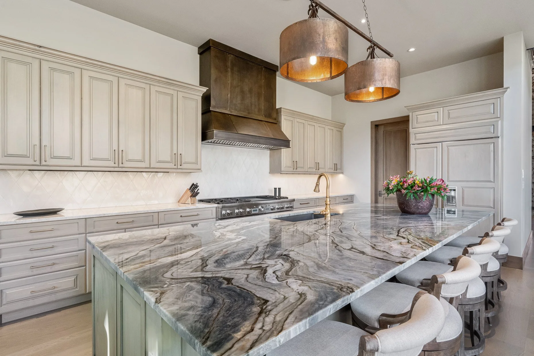 Incredible kitchen with seating for six at amazing granite countertop, off white cabinetry and designer lighting