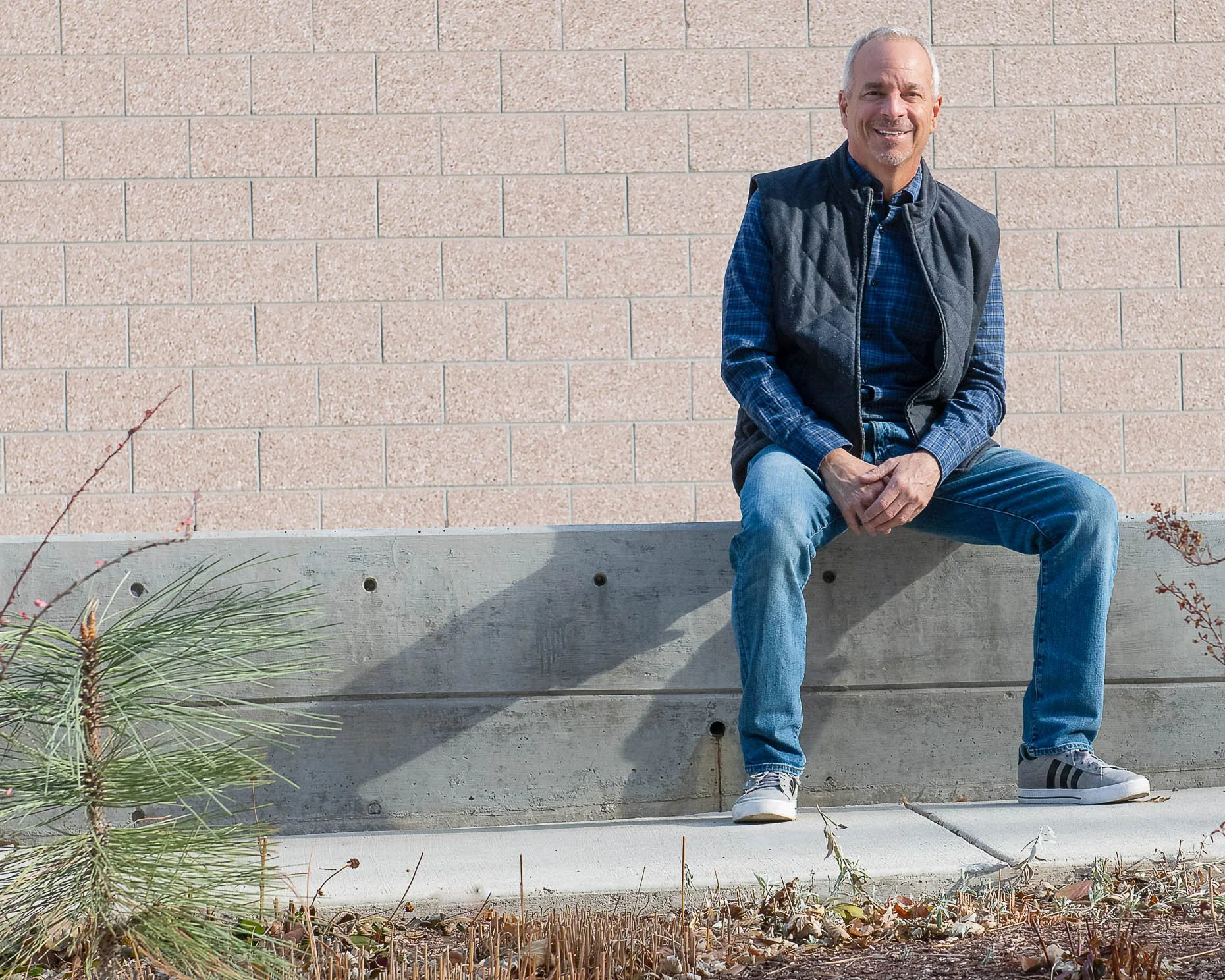 Man sitting on concrete wall
