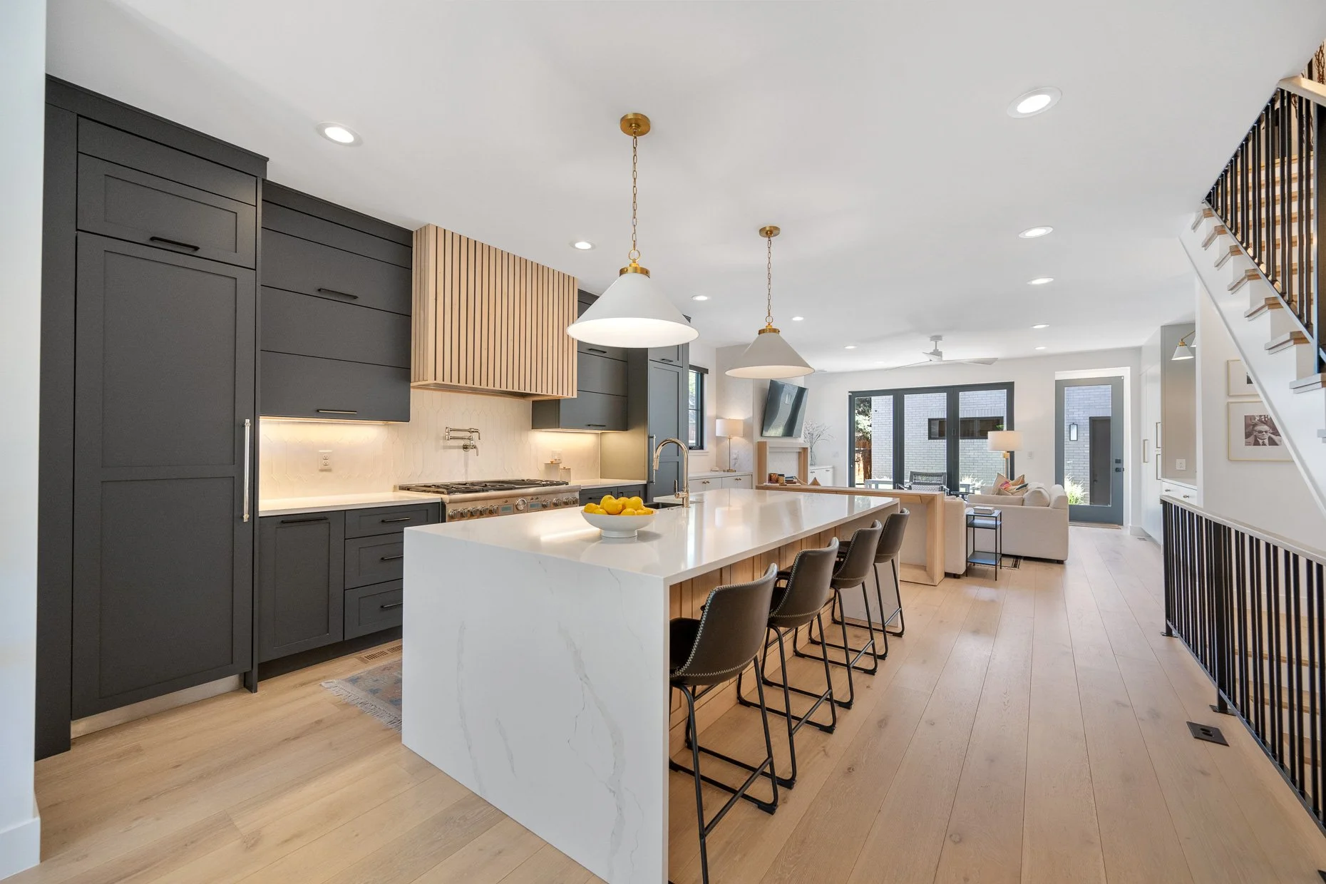 Exceptional kitchen design with fluted oven hood, seating for 4 at waterfall counter
