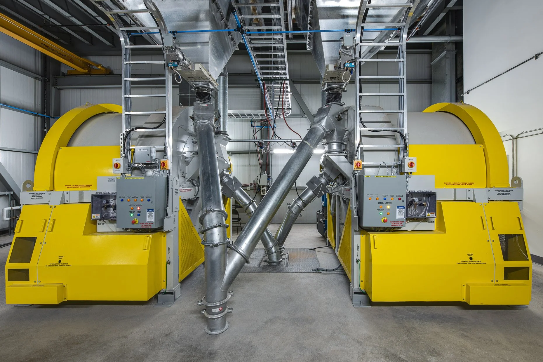 Cat litter plant with large yellow, industrial pipes and machines