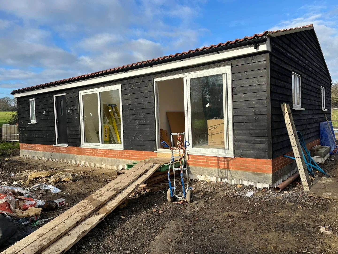 On site and nearing completion 🏡 

This 2-bedroom annex is taking shape in its rural setting, defined by dark weatherboarding and a simple, robust form. The material palette draws from agricultural precedents, helping the building sit comfortably wi