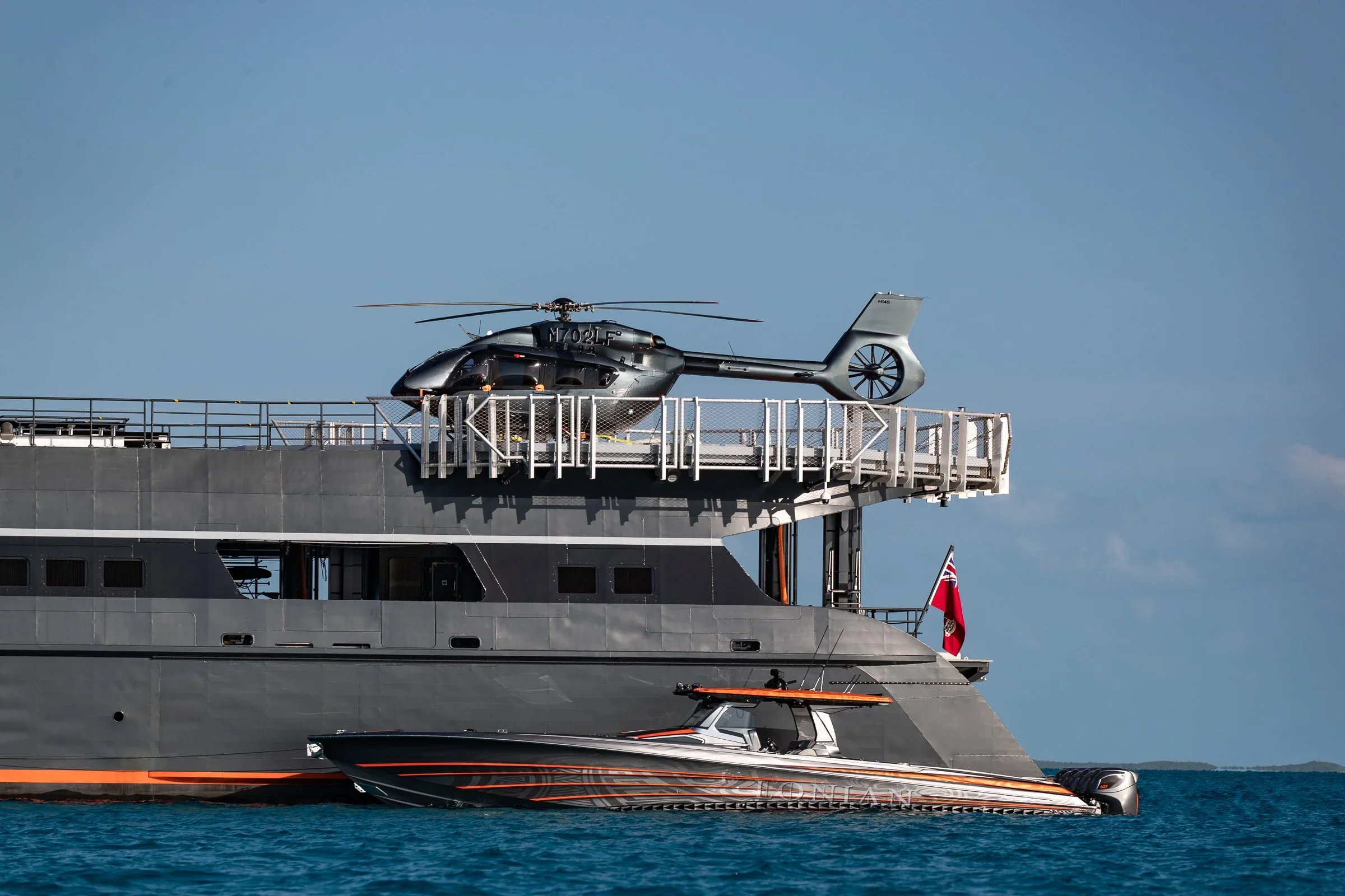 Helicopter on Hodor's helideck with a tender alongside