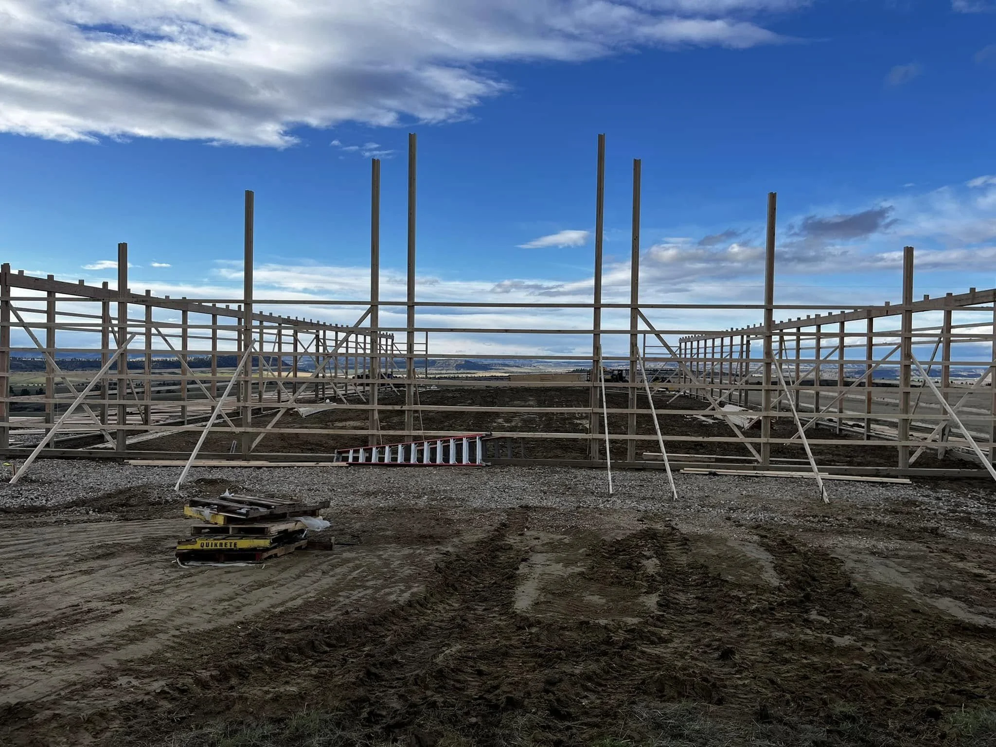 Construction site with wooden framework and scaffolding | JC Borkholder Inc