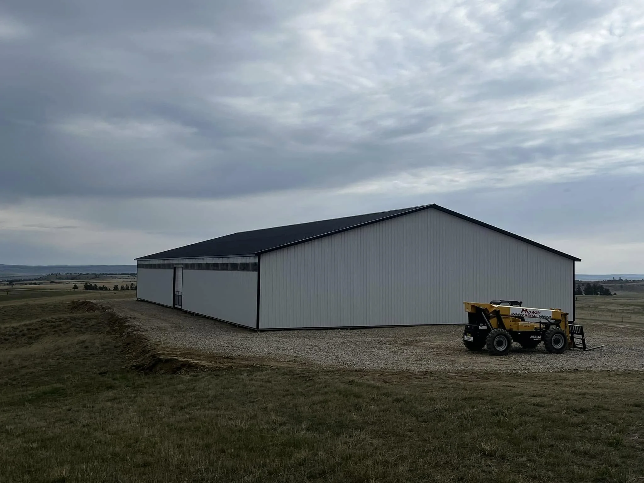 A large white metal barn 