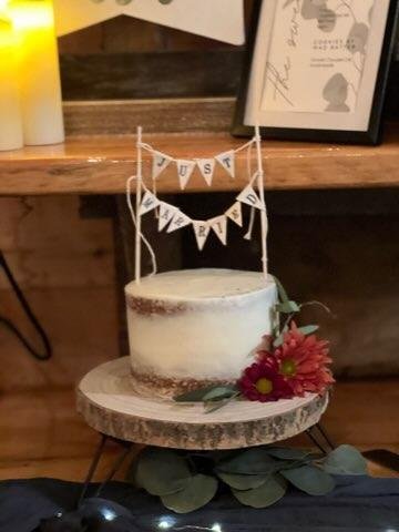 A small, rustic wedding cake with a 