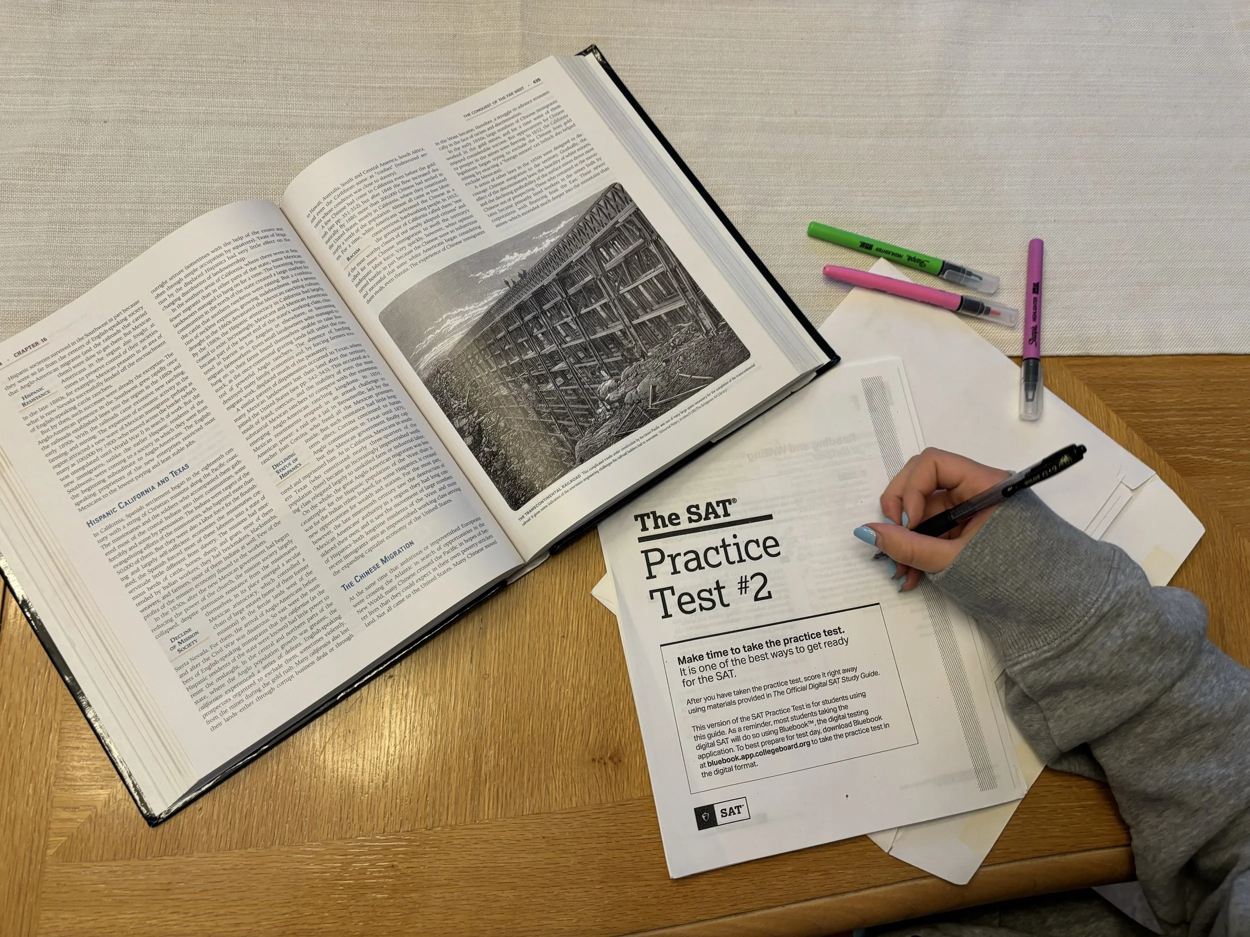 A high school student working on   'The SAT Practice Test #2'. College test prep tutoring session.