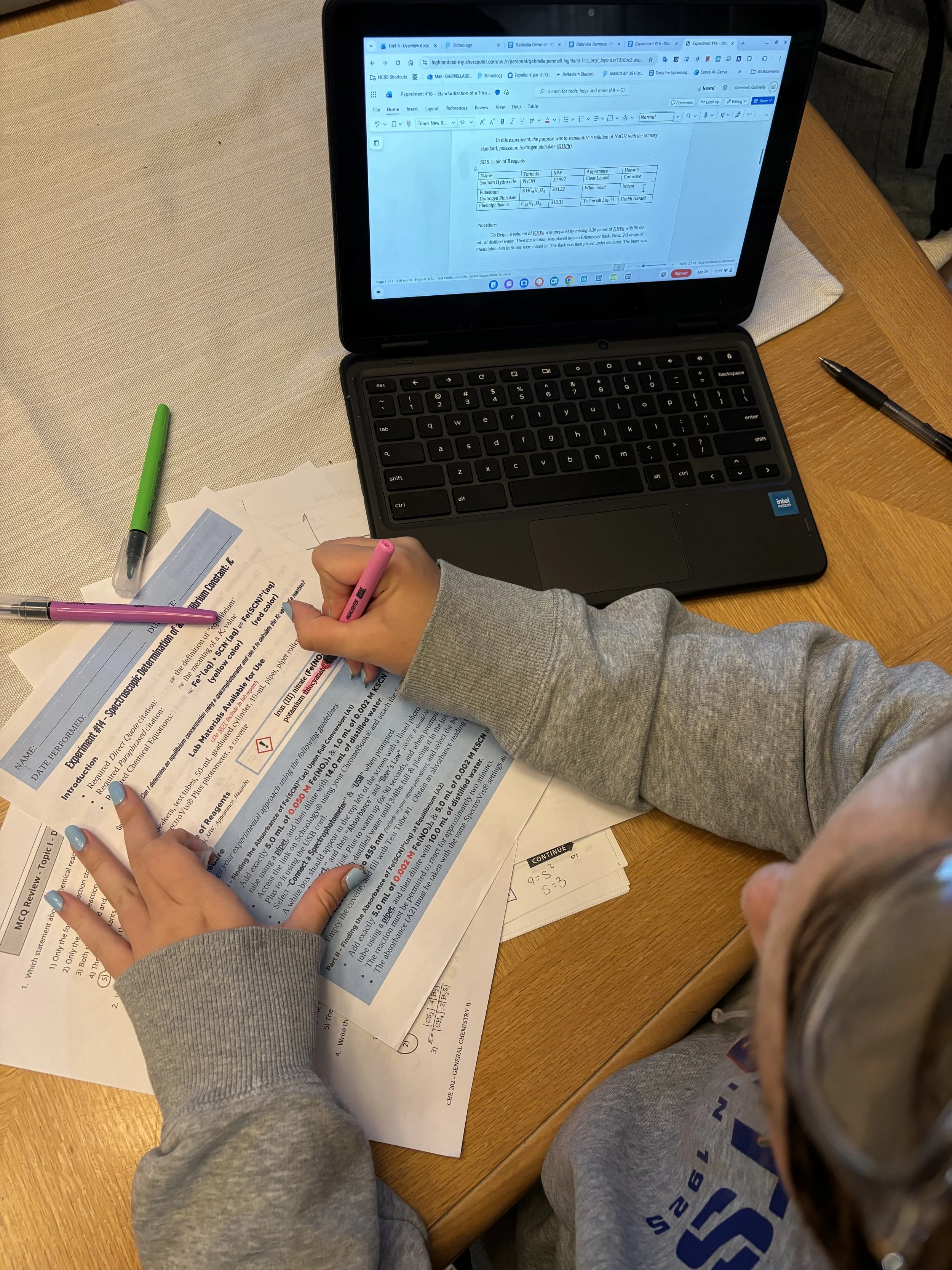 A teenager  working on a worksheet at a high school test prep tutoring session.