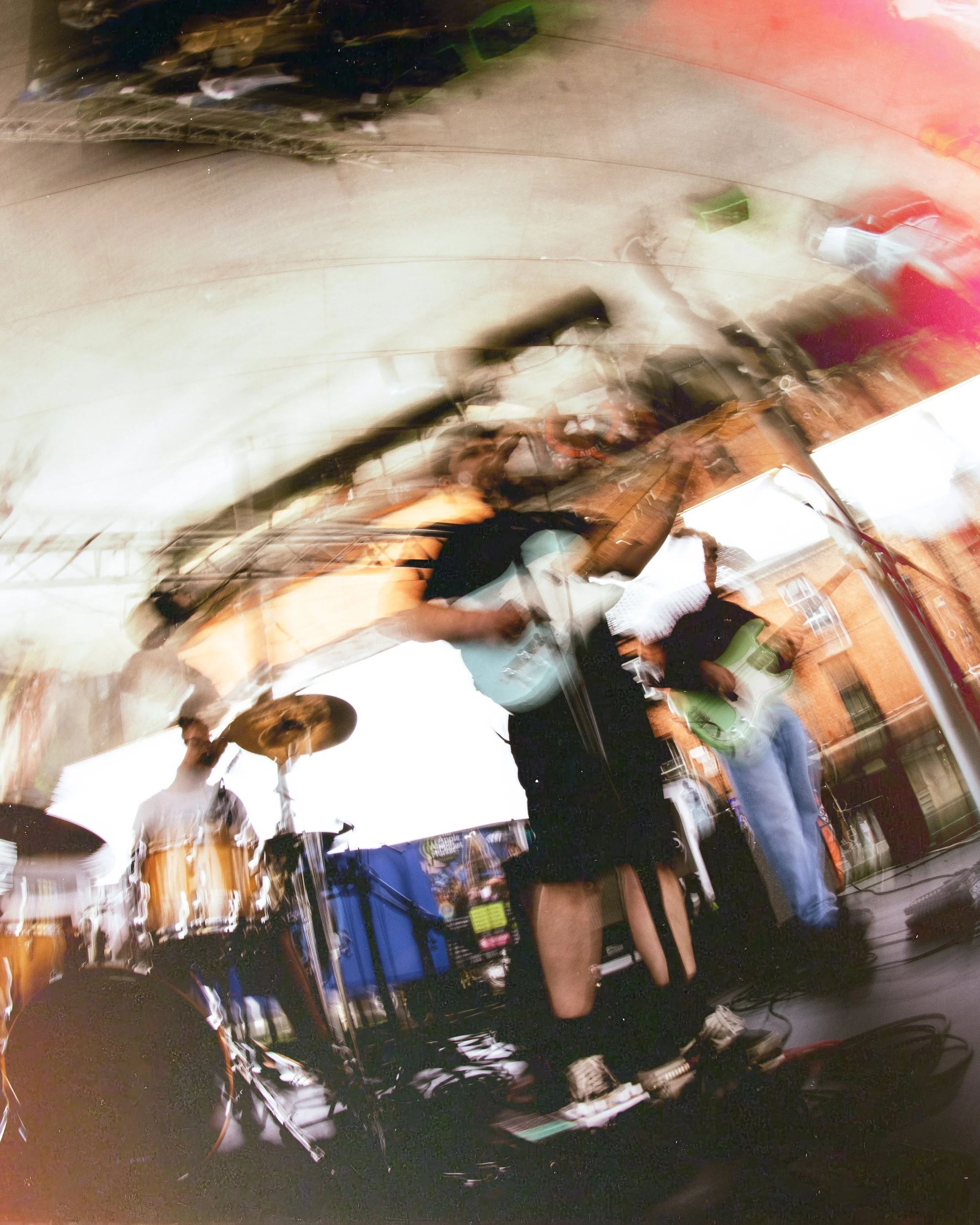 This is an abstract, blurry, and distorted photo of people shopping or working in a hardware store or warehouse. The image shows shelves, various items, and faces, but the motion blur makes it difficult to identify specific objects or individuals.