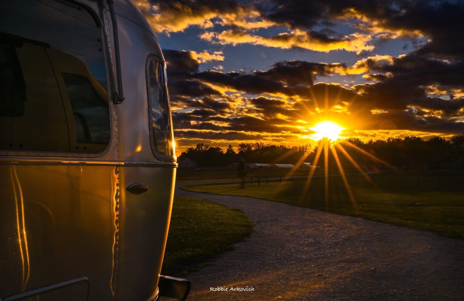 Silver riveted trailer in the warm light of a sunset