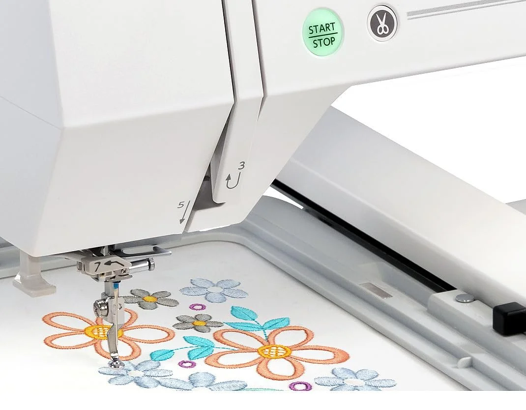 Elite Design precision embroidery machine carefully stitching a vibrant design. We use high-quality, durable threads to create beautifully personalized baby clothing, custom towels, and professional branded workwear.